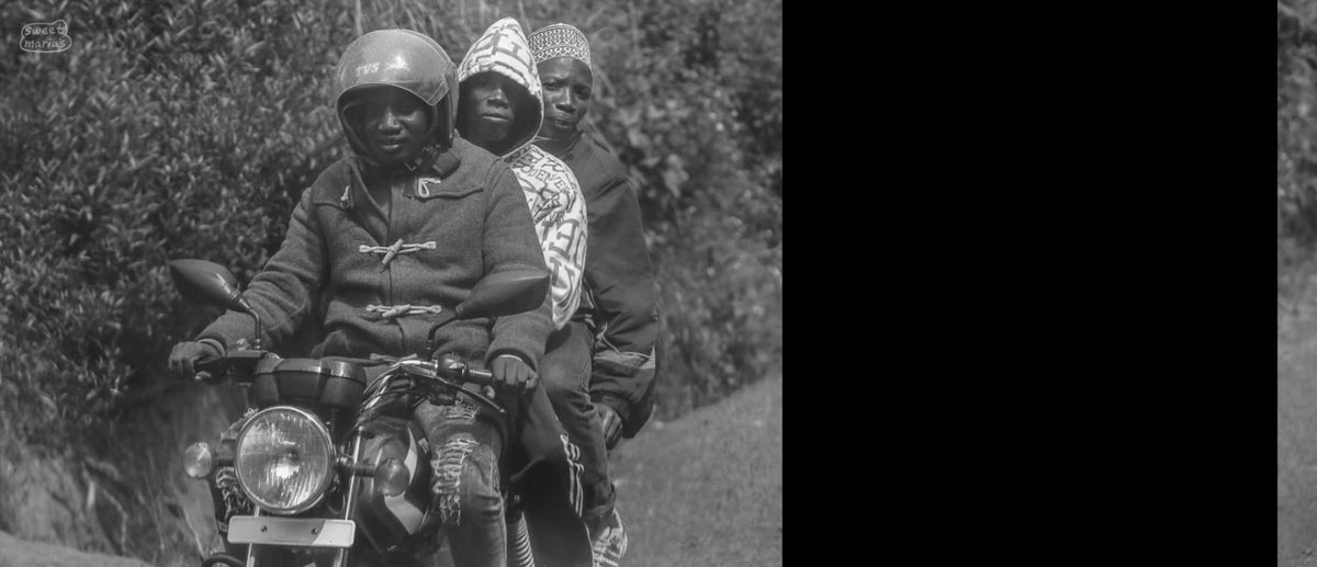 This could be a Burundian boda boda driver, or just friends/family. Whatever the case, it's quite common to ride "3-up" or more in East Africa. 