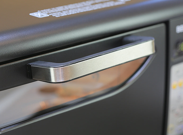 Front door handle of the Behmor 2000AB Plus electric coffee roaster. 