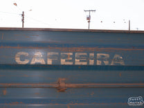 The side of a truck used to transport harvested cherry to the mill reads
