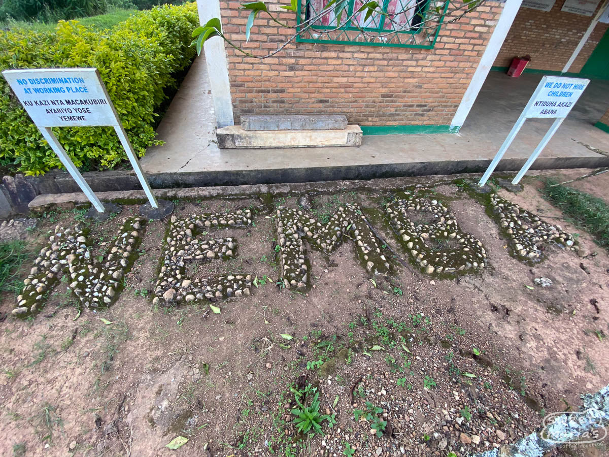 A mixture of stone and concrete is used to make a "NEMBA" relief in front of their office building at the mill in Kayanza.