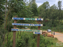 The hand-painted sign on the nearby road points the way to the Murambi coffee washing station in Muramvya, Burundi.