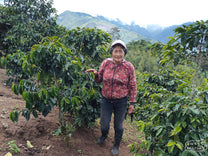 Sonia stands next to her coffee at La Loma.