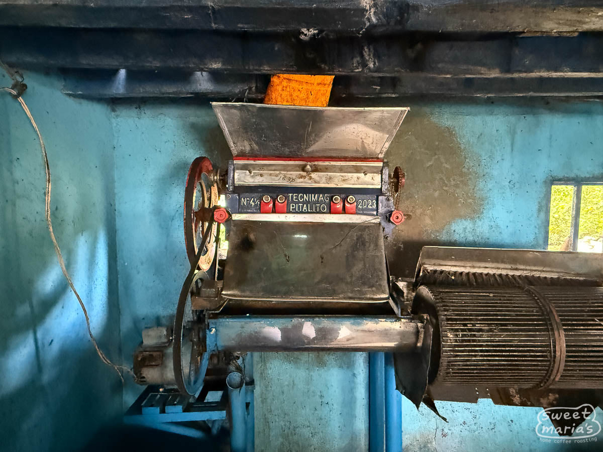 Small pulper and "criba" sorting stage (the round wire drum at right) at a farm in Pitalito.