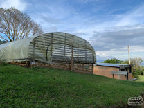 A covered drying room made from split bamboo and tarpaulin is used to dry coffee during the harvest season. Vereda Belén