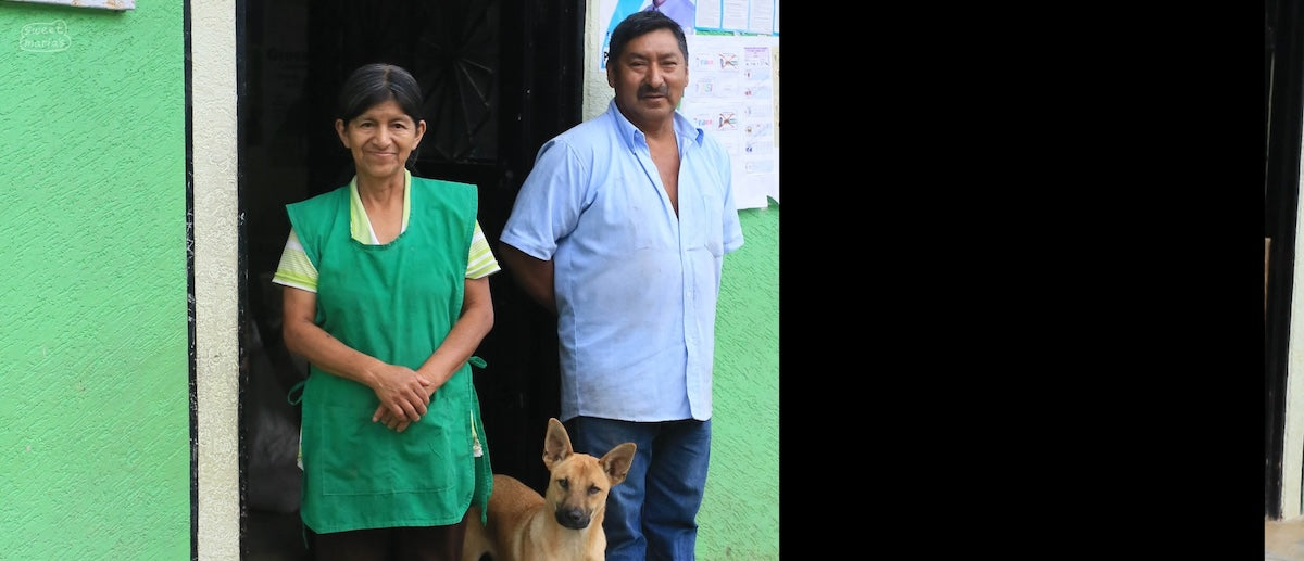 Doña Maria Rosa Oidor, stands outside her store in San Antonio town, with her husband Alfonso. In addition to running the town store, the family also acts as a central coffee buying location for farmers in Inzá, and manage their own farms too.