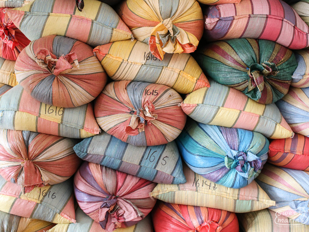 Colorful mylar bags filled with parchment coffee at the warehouse in Buesaco town, Nariño.
