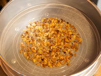 Chaff trapped in the lower tray. This is great for natural (dry-processed) coffees that tend to have more chaff.