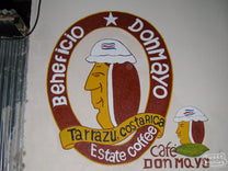 Beneficio Don Mayo sign painted on the side of the office building next to the drying patio.