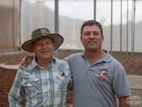 Hector (left) and Pablo (right) Bonilla pose for a "father/son" photo at their Don Mayo micromill in Tarrazu.