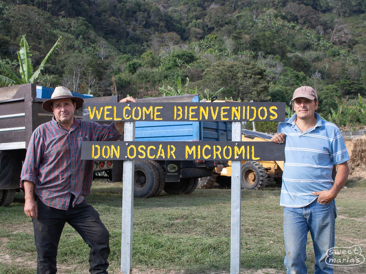 Brothers Ignacio "Tacho" (left) and Alejandro (right) Solis pose for a photo at the welcome sign leading into Don Oscar micromill, Canet de Tarrazu, Costa Rica.