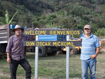Brothers Ignacio "Tacho" (left) and Alejandro (right) Solis pose for a photo at the welcome sign leading into Don Oscar micromill, Canet de Tarrazu, Costa Rica.