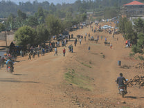 Driving down the dusty dirt road in Uraga town.