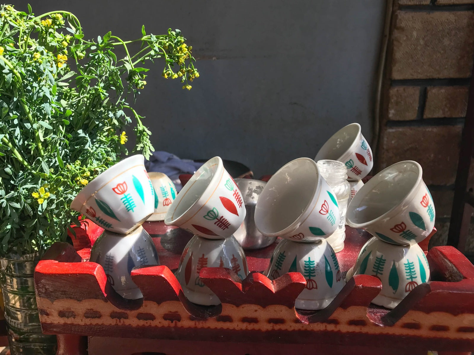 A stack of "sini" cups dries on a coffee cart in Uraga town.