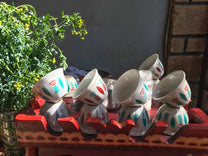 A stack of "sini" cups dries on a coffee cart in Uraga town.