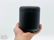  push center button to release -Fellow Atmos Vacuum Coffee Canister .7L -Black Stainless Steel