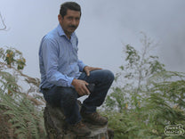 Aurelio poses for a photo on a misty morning hike above Peña Blanca town