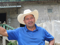 Wilmer Dubon poses for a photo at his coffee farm, El Bordo, in El Cedral, Honduras.