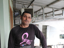 Coffee farmer Anibal Baca poses for a photo at the San Vicente mill in Santa Barbara, Honduras.