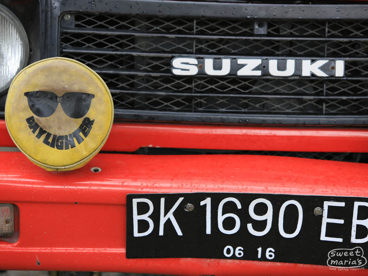 Colorful red Suzuki along the road in Java Sunda.