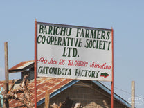 The painted sign at the entrance to the Gatomboya Factory, Nyeri, Kenya.