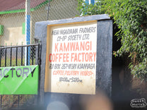 The hand-painted "Kamwangi Coffee Factory" sign outside the wet mill in Kirinyaga, Kenya.