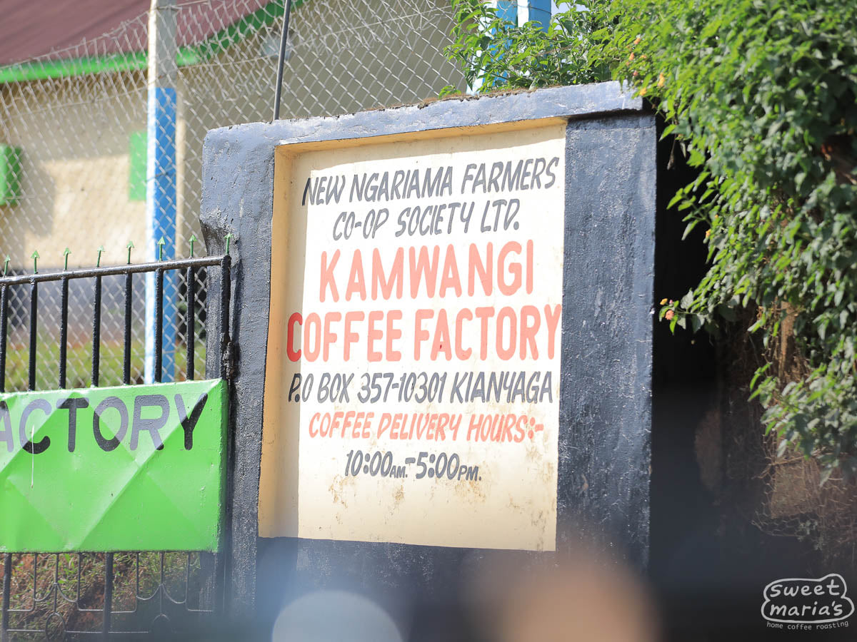 The hand-painted "Kamwangi Coffee Factory" sign outside the wet mill in Kirinyaga, Kenya.