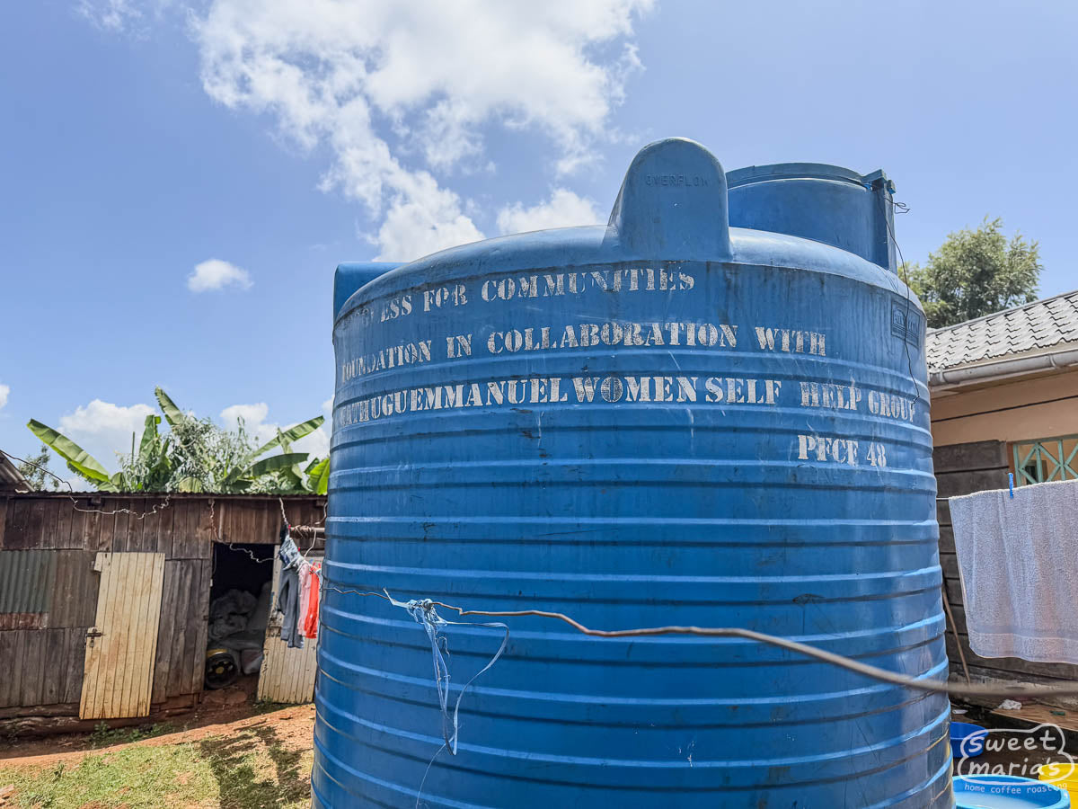 Large blue water tank for community use at the Spike farm site in Kiambu.