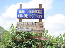 The wooden sign at Ndiara Factory, a coffee washing station under the Kiru Farmers Cooperative Society in Muranga, Kenya.