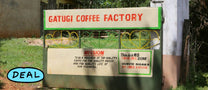 A hand-painted sign that reads "Gatugi Coffee Factory Delivery Gate" directs farmers bringing coffee cherry from the day's harvest to be processed at the washing station. Nyeri, Kenya.