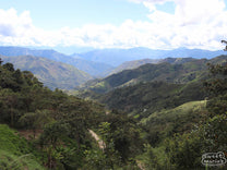 Looking down at a plunging valley while touring farms in Huabal District.
