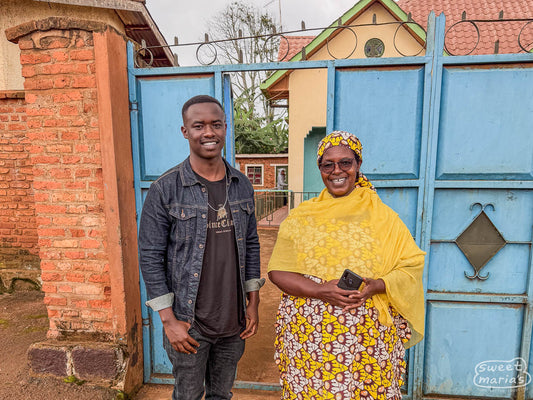 Owner Beathe on the right, and her son Sam on the left, in front of the gate to Mushaka Station in Rusizi, Rwanda.