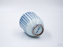 The Blue Tokusa Cup features a striped Tokusa pattern with bronze accents.