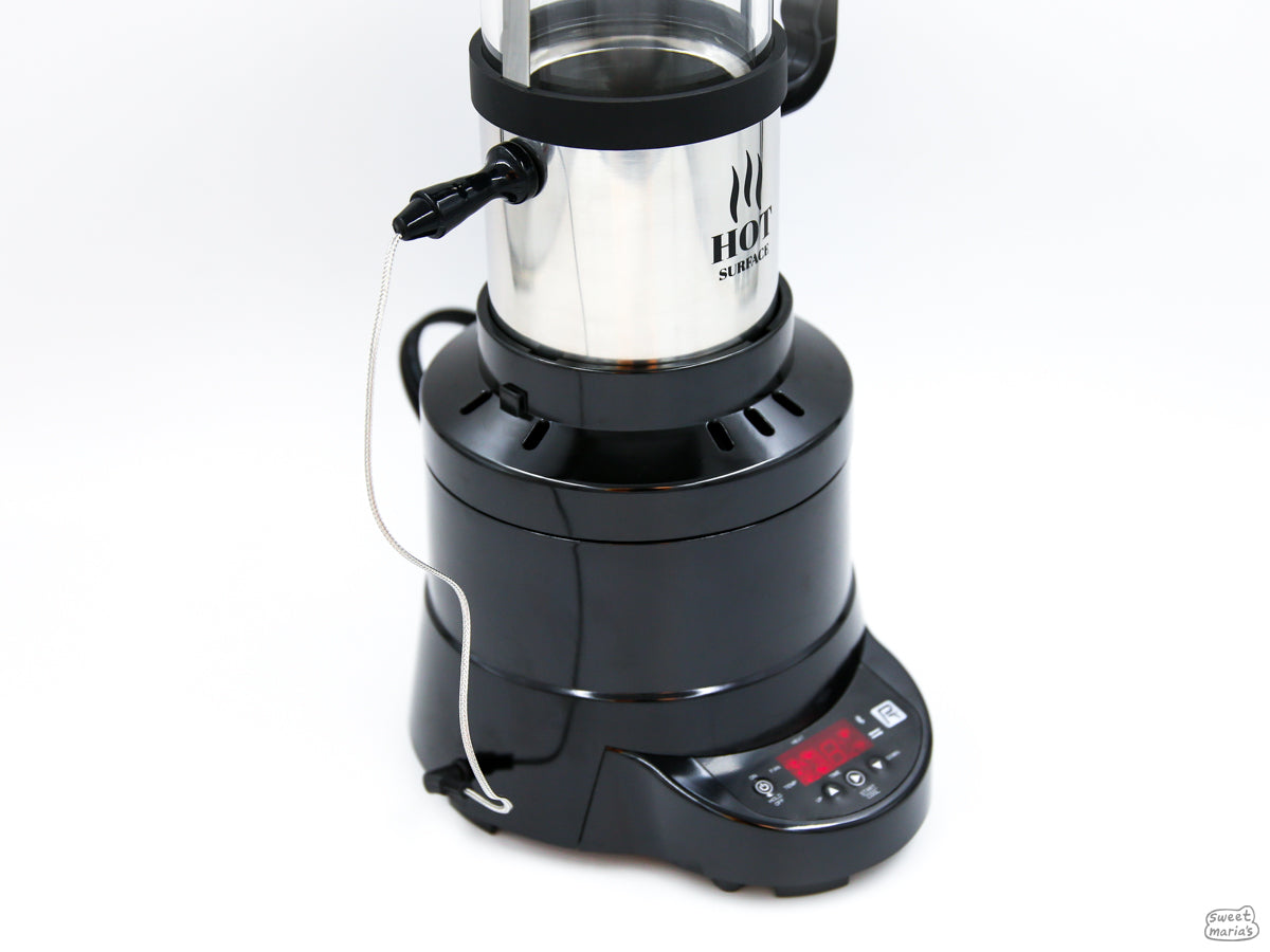 The bean temperature probe inserts into the side of the roast chamber and connects to the bottom of the roaster via cable.