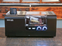 The Gene Cafe CBR-301 is a hybrid air and drum roaster with increased batch size, updated drum and fan settings, and app connectivity via bluetooth.