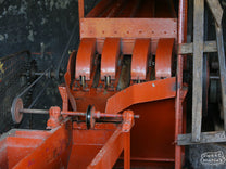 Typical "Mckinnon" style disc depulper used for removing the outer cherry skin and fruit from the green coffee seed. This is at another of the wet mills under the Othaya Cooperative Society in Nyeri, Kenya.