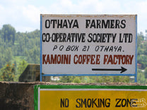 The hand painted sign marking the entrance to the Kamoini coffee factory where all of the green coffee from cooperative members is processed. Nyeri, Kenya.