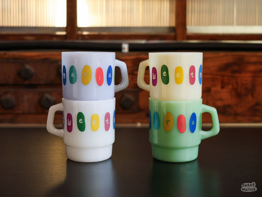 The Sweet Maria's Milk Glass Mugs are stackable, made of thick, opaque colored glass.