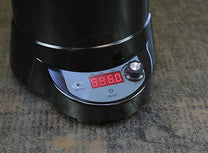The SR540 control panel on the base of the roaster. A run/cool cycle button on the left and an on/off button in the center. A knob on the right allows users to control the fan speed